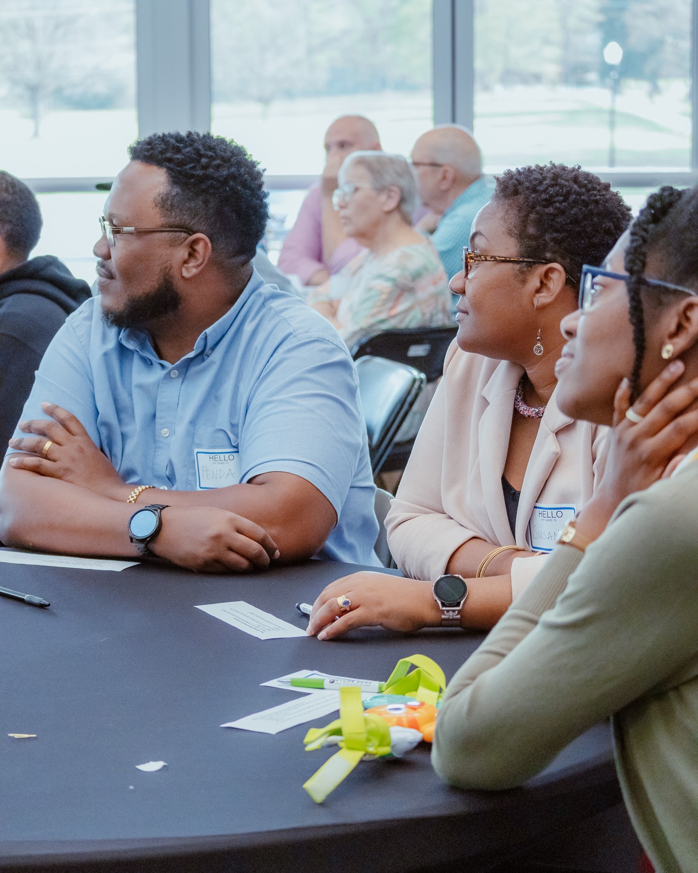Students seated at tables with name tags and notebooks during a Stone Edge School of Ministry class