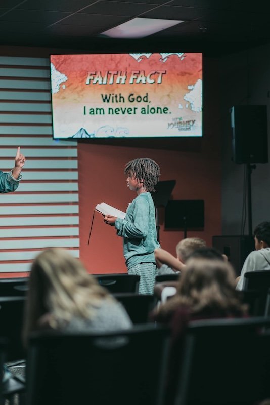 A child reading the Bible at Stone Edge Kids