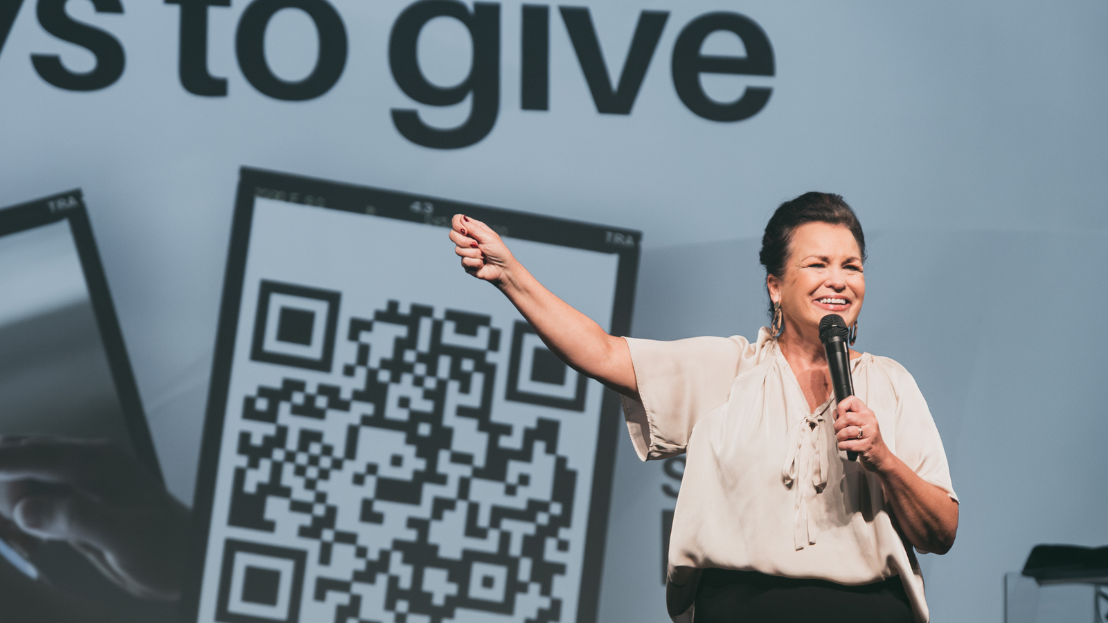 Pastor on stage during a Ways to Give moment at Stone Edge Church